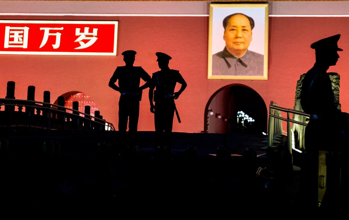 Chinese Paramilitary police officers stand guard below a portrait of the late leader Mao Zedong in front of the Forbidden City at Tiananmen Square in Beijing, China, on June 4, 2014. (Kevin Frayer/Getty Images)