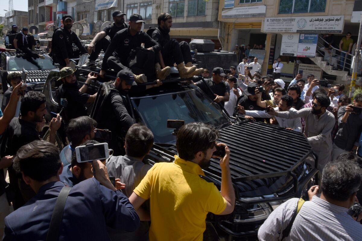 Private security personnel clear the way for a vehicle carrying Pakistan's former Prime Minister Imran Khan arriving for court appearance, in Islamabad, Pakistan, on May 9, 2023. (Ghulam Farid/AP Photo)