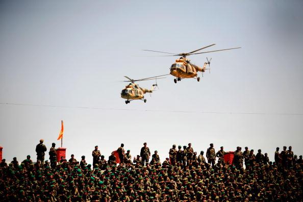 Afghan National Army (ANA) Russian-made helicopters fly past during a ceremony to commemorate the anniversary of the fall of a Soviet-installed regime on April 28, 2010 in Kabul, Afghanistan. (Majid Saeedi/Getty Images)
