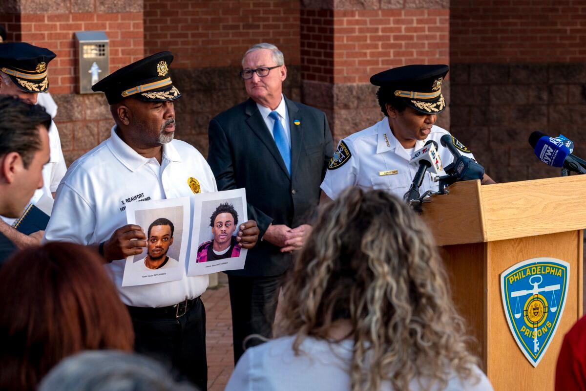 Department of Prisons Commissioner Blanche Carney (R) updates news media outside the Philadelphia Industrial Correctional Center on May 8, 2023, on the recent escape of two prisoners as Mayor Jim Kenney is in rear, and Xavier Beaufort (L), Deputy Prisons Commissioner holds photos of the two escapees. (Tom Gralish/The Philadelphia Inquirer via AP)