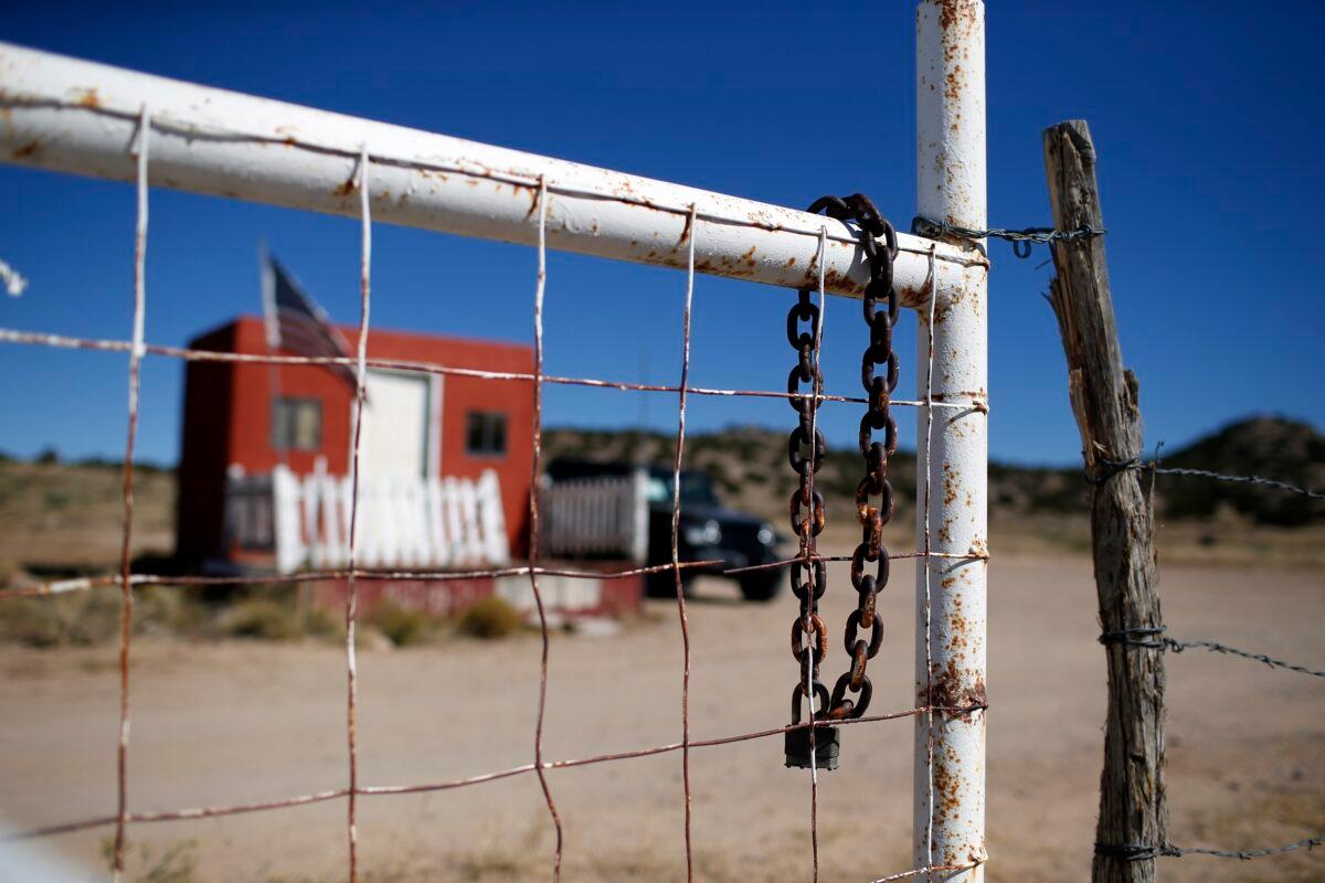 A rusted chain hangs on the fence at the entrance to the Bonanza Creek Ranch film set in Santa Fe, N.M., on Oct. 27, 2021. (Andres Leighton/AP Photo)