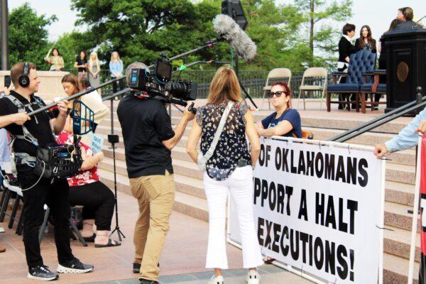 Anti death penalty activists speak to media during a rally on May 9, 2023 for Oklahoma death row inmate Richard Glossip. (Michael Clements/The Epoch Times)