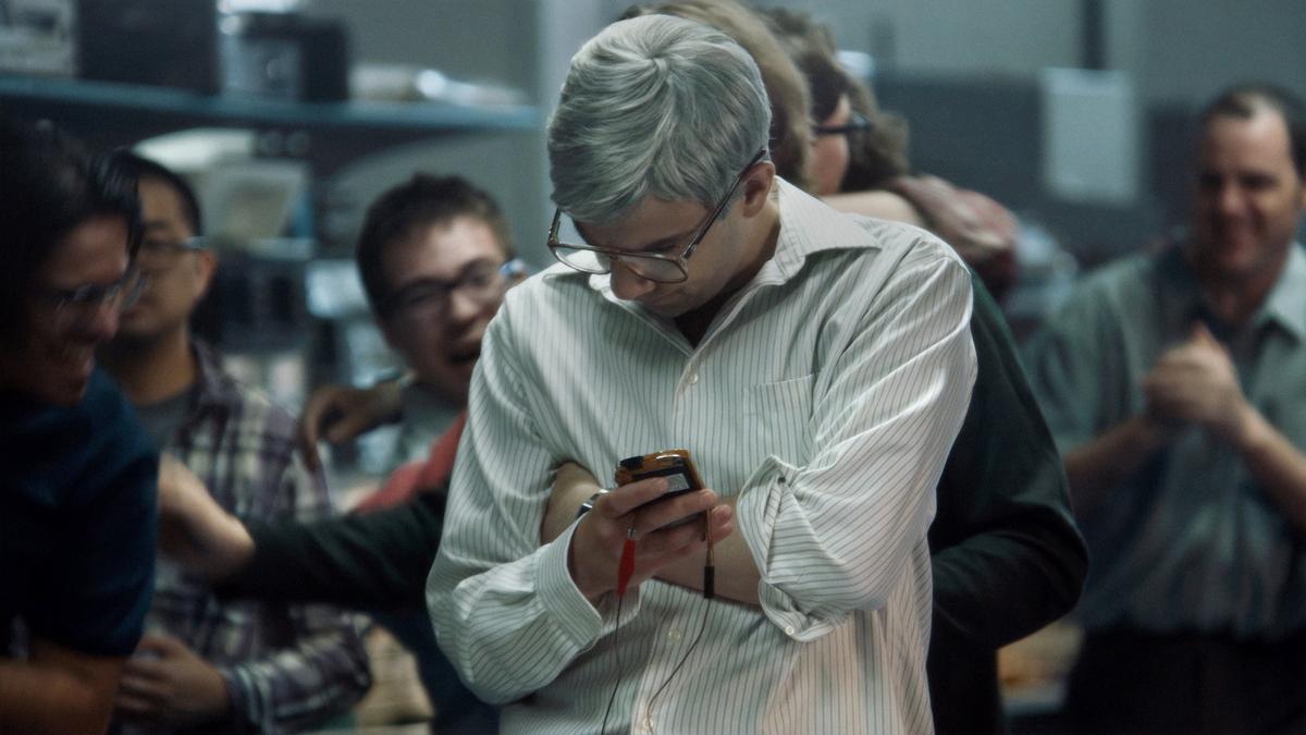 Mike Lazaridis (Jay Baruchel, C) is not quite grasping the fact that the familiar and comforting clicking noise of the BlackBerry keyboard is not going to be enough to keep the deadly iPhone at bay, in the tech biopic "BlackBerry." (Zapruder Films/Elevation Pictures)