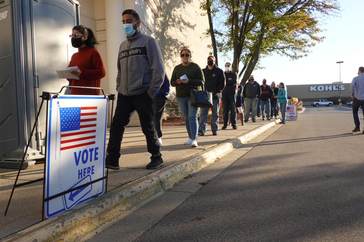 Residents wait in line to vote at a shuttered Sears store in the Janesville Mall in Janesville, Wis., on Nov. 3, 2020. (Scott Olson/Getty Images)