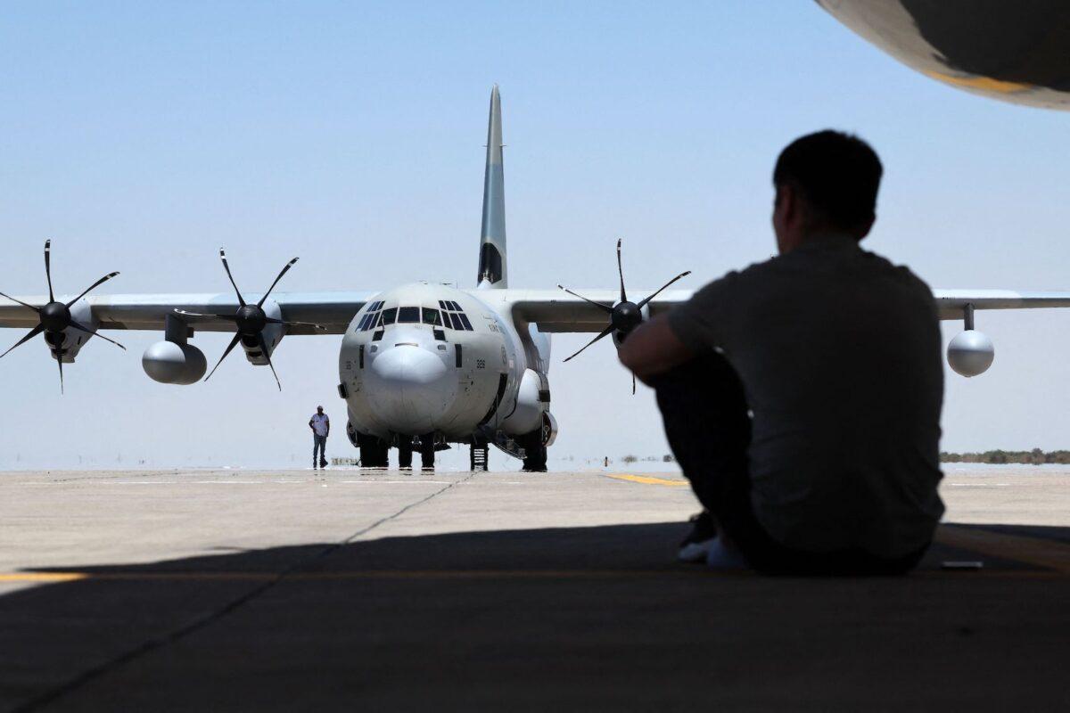 A man looks on as an aircraft carrying supplies from Kuwait has just landed at the Port Sudan airport, on May 5, 2023. (Giuseppe Cacace/AFP via Getty Images)