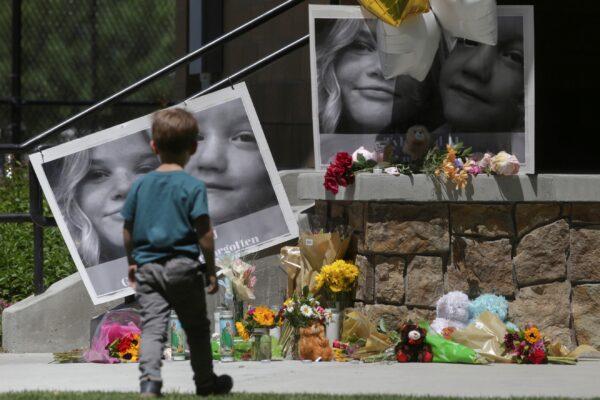 A boy looks at a memorial for Tylee Ryan and Joshua "JJ" Vallow in Rexburg, Idaho on June 11, 2020. (John Roark/The Idaho Post-Register via AP)