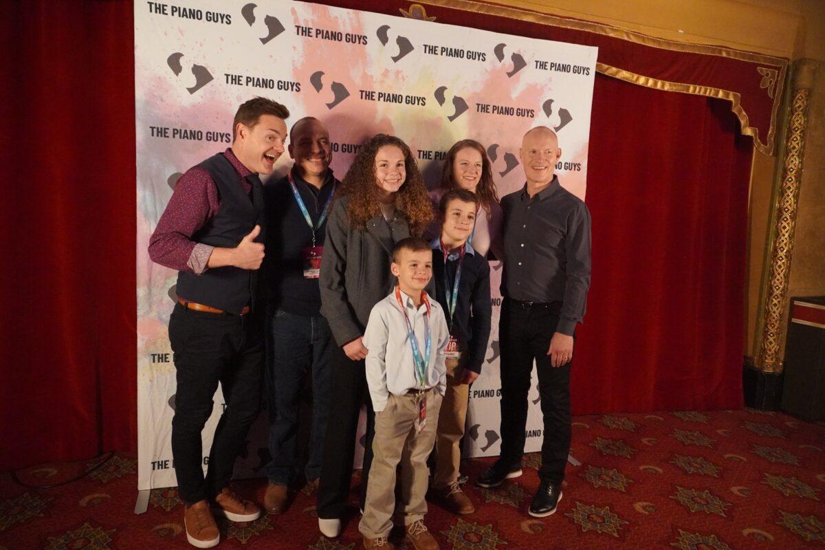 Steven Sharp Nelson (L) and Jon Schmidt (R) pose with the Diaz family during a post-concert meet-and-greet in Atlanta on Nov. 29, 2022. (Nanette Holt/The Epoch Times)