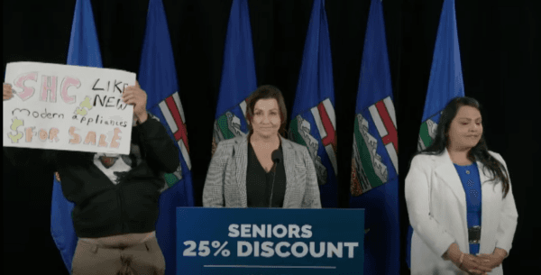 A protestor disrupts a UCP press conference in Calgary on May 11, 2023, in a screengrab from video. (UCP/Screenshot via The Epoch Times)