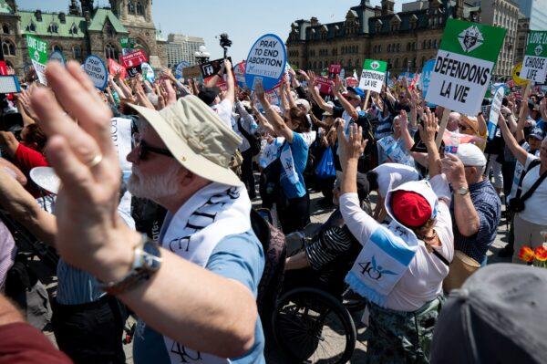 Demonstrators take part in a prayer during the March for Life event on Parliament Hill in Ottawa on May 11, 2023. (The Canadian Press/Spencer Colby)