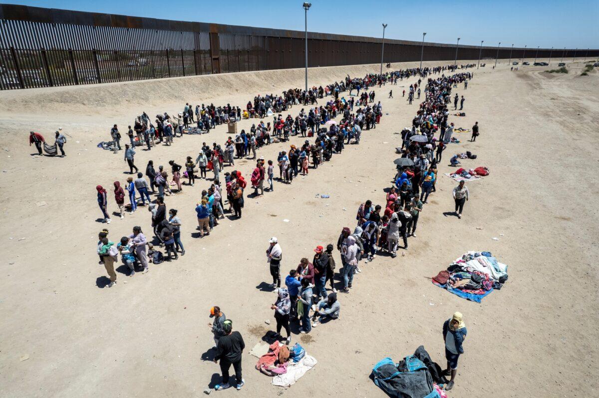 In an aerial view, immigrants line up to be processed to make asylum claims at a makeshift migrant camp in El Paso, Texas, on May 11, 2023. (John Moore/Getty Images)