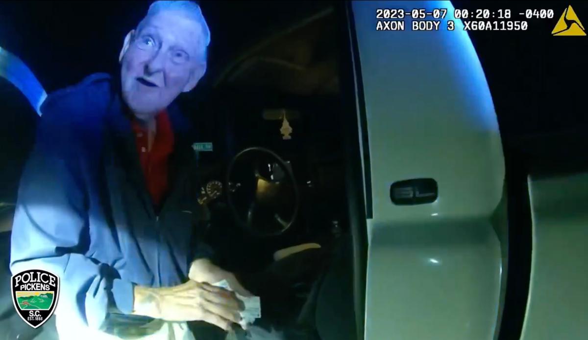 Body camera footage shows the pickup truck's driver, Fred, interacting with Officer Woodmansee before offering her an impromptu two-step performance on the side of the road. (Courtesy of Pickens Police Department)