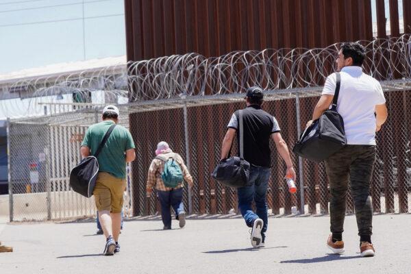 Day workers walk back into Mexico through the San Luis, Ariz., port of entry on May 11, 2023. (Allan Stein/The Epoch Times)