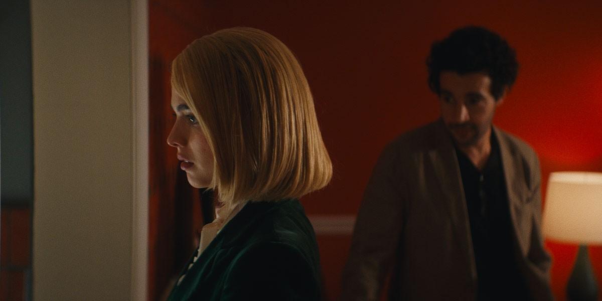 Rebecca (Margaret Qualley)—<em>a lawyer</em> (cough-cough), and her—ahem—<em>client,</em> Hal (Christopher Abbott) in "Sanctuary." (Rumble Films/Neon)