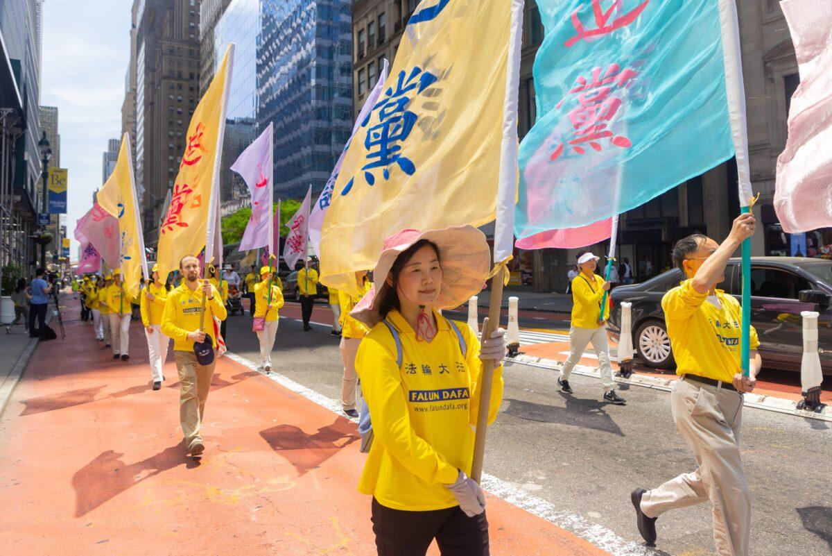 Falun Gong practitioners march in Manhattan to celebrate World Falun Dafa Day on May 12, 2023. (Mark Zou/The Epoch Times)