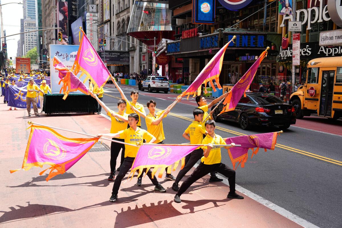 Falun Gong practitioners march in Manhattan to celebrate World Falun Dafa Day on May 12, 2023. (Larry Dye/The Epoch Times)