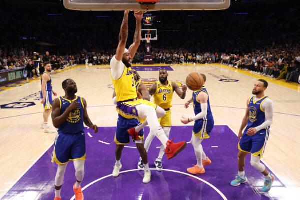 Anthony Davis (3) of the Los Angeles Lakers dunks past Draymond Green (23) of the Golden State Warriors during the third quarter in game six of the Western Conference Semifinal Playoffs in Los Angeles on May 12, 2023. (Harry How/Getty Images)