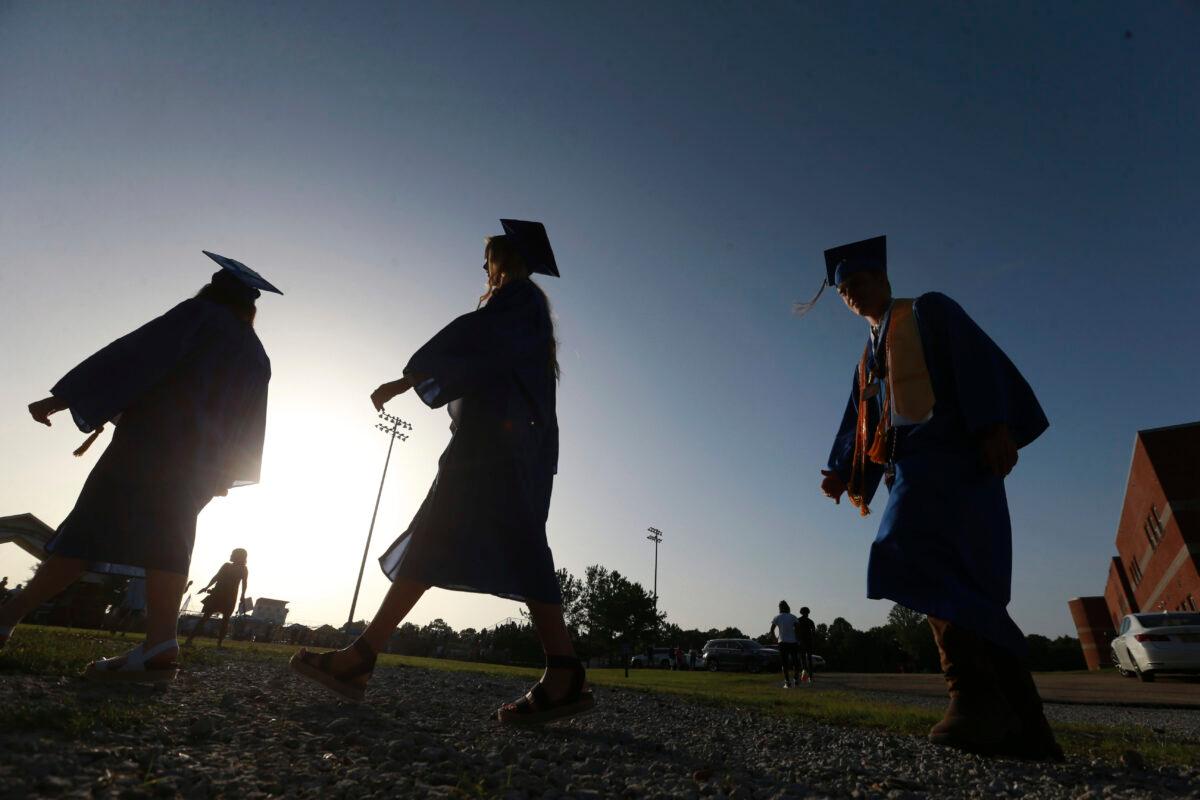 High school seniors make their way to the football field for their graduation ceremony in Saltillo, Miss., June 27, 2020. (Thomas Wells/AP)