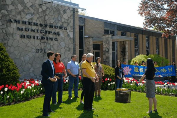 Michael Prue (front C), Mayor of Amherstburg, Ont., and several city councillors learn the Falun Dafa exercises at a flag-raising ceremony outside of the municipal building on May 5, 2023. The councillors include Linden Crain (L), Diane Pouget (2nd L), Deputy Mayor Chris Gibb (3rd L), and Molly Allaire (5th L). (The Epoch Times)