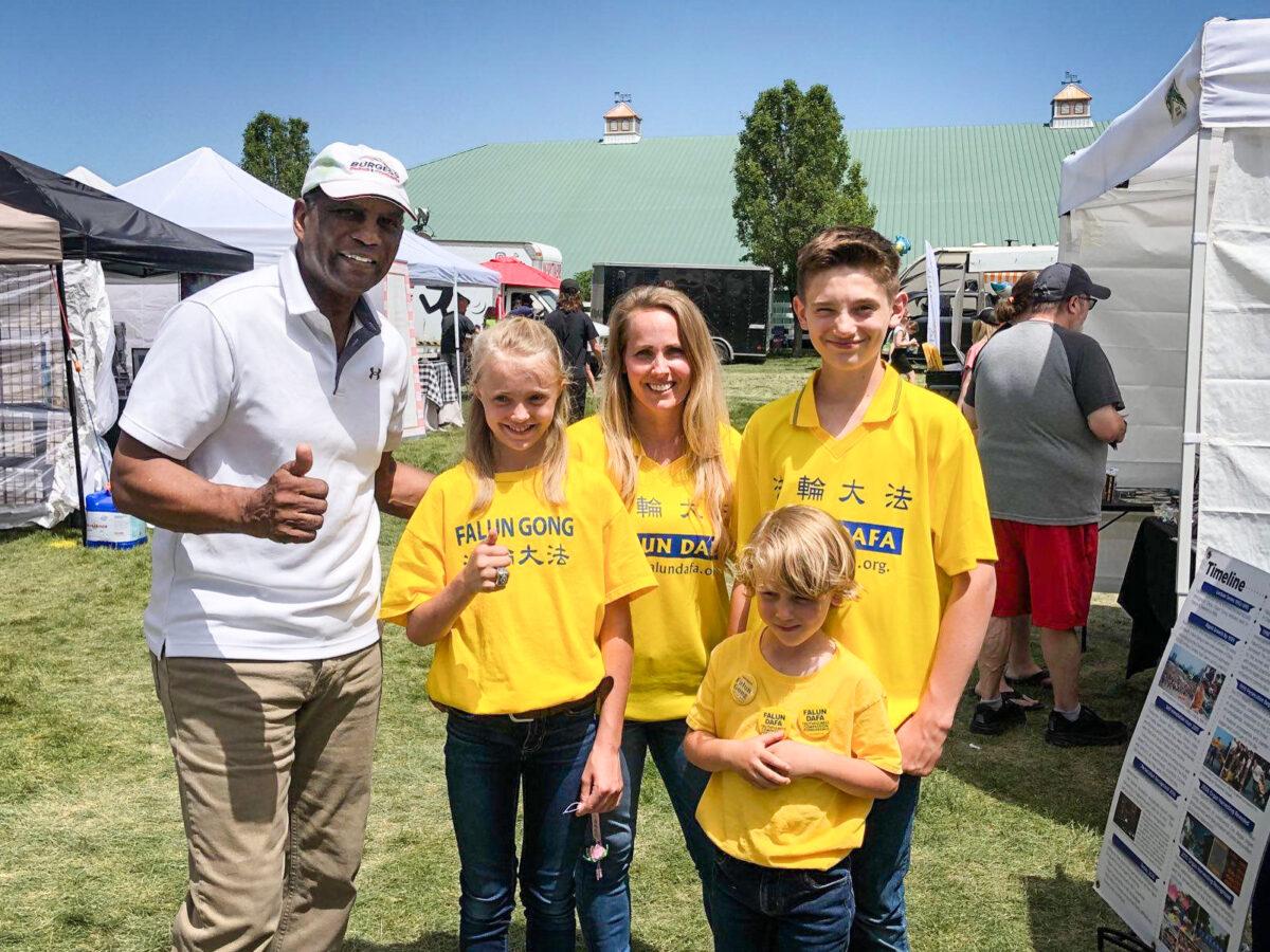 Rep. Burgess Owens (R-Utah) poses with Jami Smith and her children at an event in Herriman, Utah, in June 2022. (Courtesy of Jami Smith)