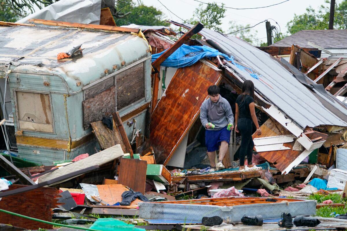 People salvage items from a home after a tornado hit, in the unincorporated community of Laguna Heights, Texas, near South Padre Island, on May 13, 2023. (Julio Cortez/AP Photo)