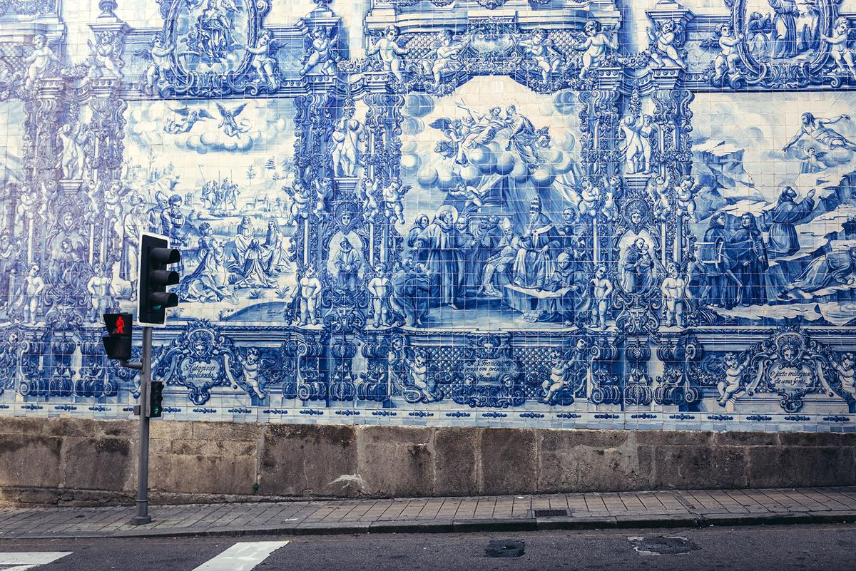 Characteristic azulejo tile work along the side of Chapel of Souls in Porto, Portugal. (Fotokon/Shutterstock)