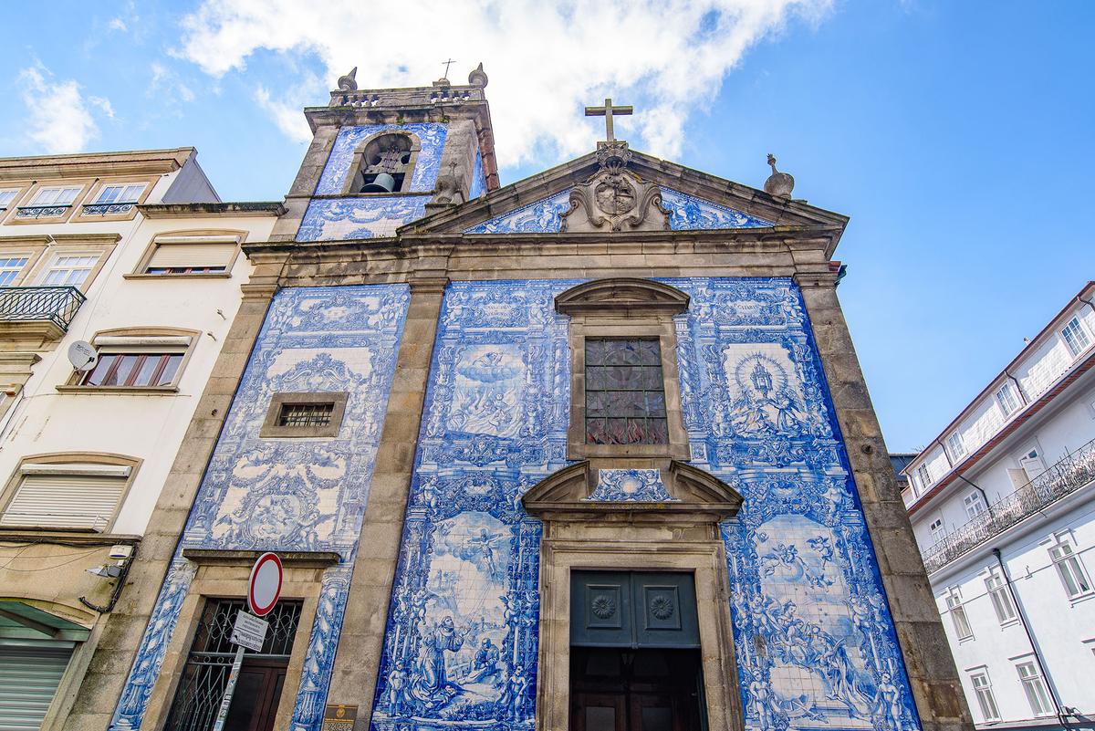 The impressive front of Chapel of Souls, decorated with azulejo tiles in Porto, Portugal. (Mo Wu/Shutterstock)