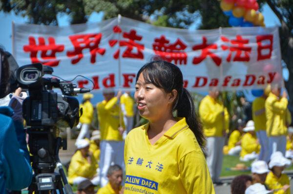 Falun Gong practitioner Fangwei Xu joins the Falun Dafa Day celebration in Santa Monica, Calif., on May 7, 2023. (Alex Lee/The Epoch Times)