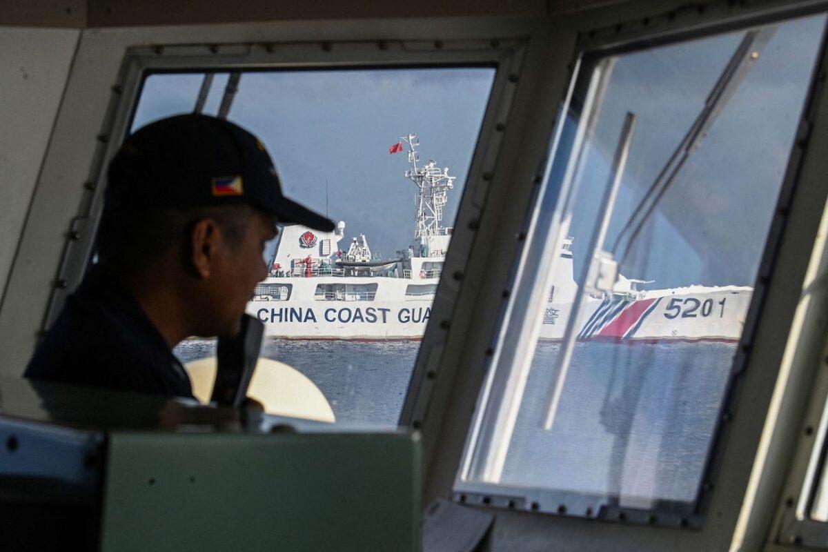 A member of the Philippine coast guard vessel BRP Malabrigo manning his post while being shadowed by a Chinese coast guard ship at Second Thomas Shoal in the Spratly Islands in the disputed South China Sea, on April 23, 2023. (Ted Ajibe/AFP via Getty Images)