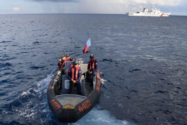 Personnel of the Philippine Coast Guard ship BRP Malabrigo aboard their rigid hull inflatable boat preparing to conduct a survey in the waters of Second Thomas shoal in the Spratly Islands in the disputed South China Sea, on April 23, 2023. (Red Ajibe/AFP via Getty Images)