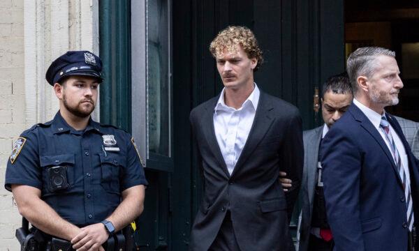 Daniel Penny (C) is walked by New York Police Department detectives out of the 5th Precinct in New York on May 12, 2023. (Jeenah Moon/AP Photo)