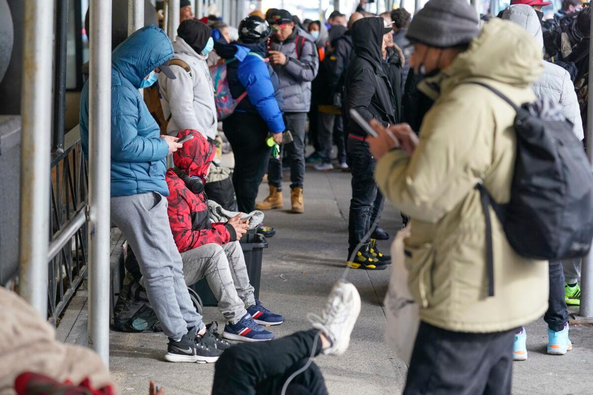 Illegal immigrants with their belongings on the sidewalk in front of the Watson Hotel in New York on Jan. 30, 2023. (Seth Wenig/AP Photo)