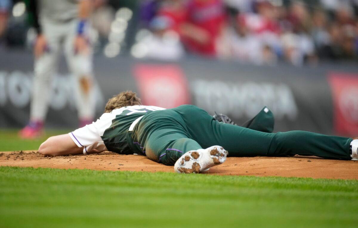 Colorado Rockies starting pitcher Ryan Feltner lies on the mound after getting hit by a single by Philadelphia Phillies' Nick Castellanos during the second inning of a baseball game in Denver on May 13, 2023. (David Zalubowski/AP Photo)
