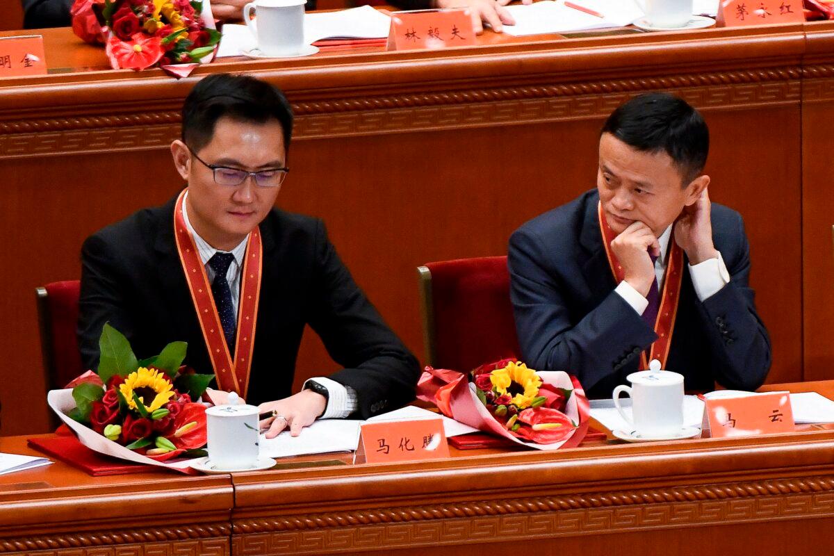 Alibaba's co-founder Jack Ma (R) looks at Tencent Holdings' CEO Pony Ma during a celebration meeting marking the 40th anniversary of China's "reform and opening up" policy at the Great Hall of the People in Beijing on Dec. 18, 2018. (Wang Zhao/AFP via Getty Images)
