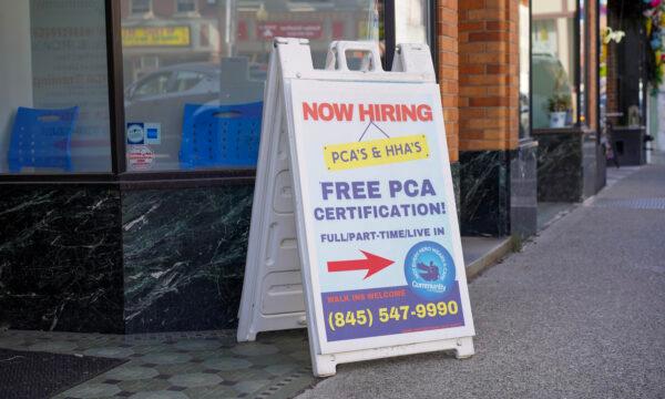 A hiring sign for home aids on North Street in Middletown, N.Y., on May 15, 2023. (Cara Ding/The Epoch Times)