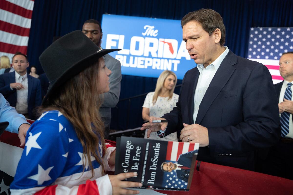 Florida Gov. Ron DeSantis reacts after signing a copy of his new book, "The Courage to Be Free: Florida's Blueprint for America's Revival," at the North Charleston Coliseum in North Charleston, S.C., on April 19, 2023. (Sean Rayford/Getty Images)