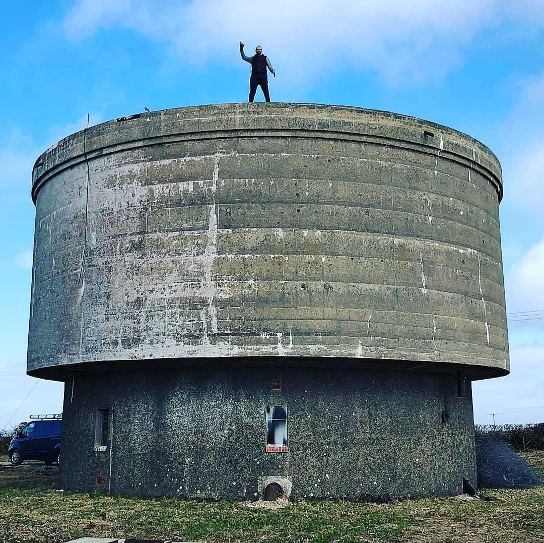 Rob Hunt on the abandoned water tower before it was renovated. (Courtesy of <a href="https://www.instagram.com/water_tower_conversion/">Rob Hunt</a>)