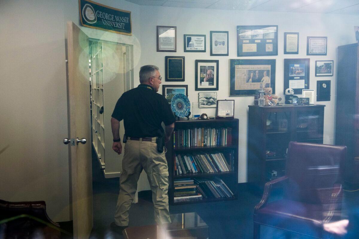 A law enforcement officer surveys the office of Rep. Gerry Connelly (D-Va.) in Fairfax, Va., on May 15, 2023, after police say a man wielding a baseball bat attacked two staffers for Connolly on Monday morning. (Cliff Owen/AP Photo)