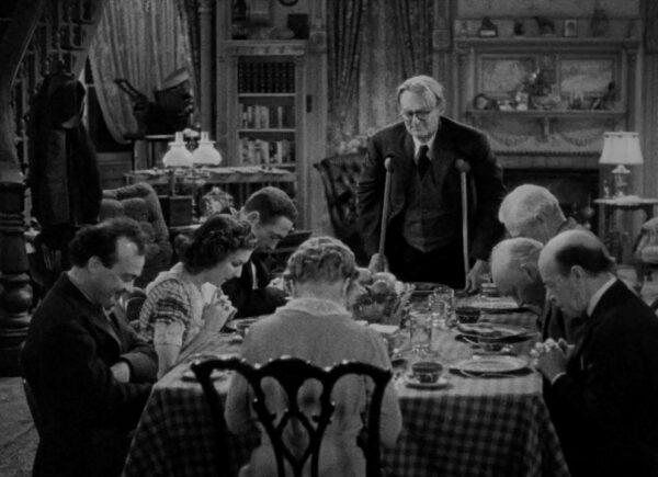 Grandpa Vanderhof (Lionel Barrymore) leads the family in prayer at the dinner table, in "You Can't Take It With You." (Columbia Pictures)