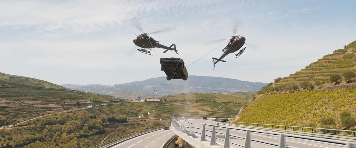 Yes, you guessed correctly—that right there would be a photo of two helicopters spearfishing a muscle car, and then hoisting it off the highway, in "Fast X." (Peter Mountain/Universal Pictures)
