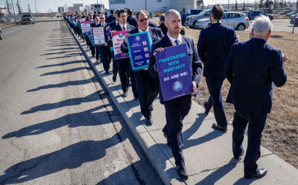 Members of the Air Line Pilots Association demonstrate amid contract negotiations outside the WestJet headquarters in Calgary, Alta., Friday, March 31, 2023.THE CANADIAN PRESS/Jeff McIntosh