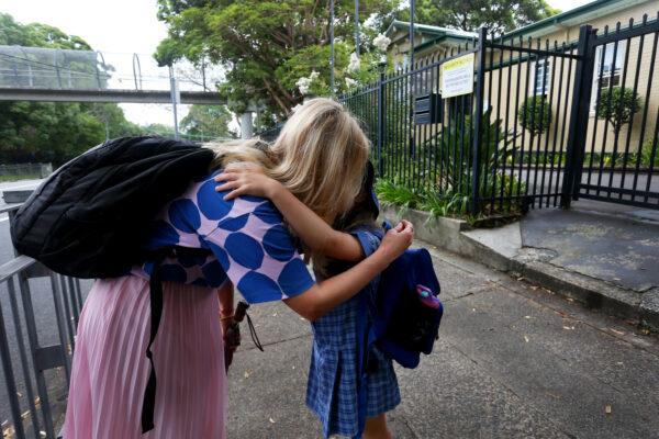 A mother hugs and says goodbye to her daughter at her school gates in Sydney, Australia, on Feb. 20, 2023. (Lisa Maree Williams/Getty Images)