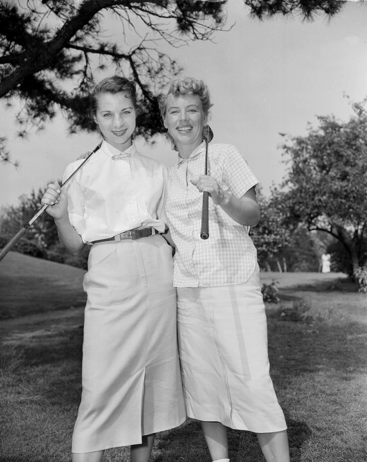 Marlene Bauer (L) and Alice Bauer pose before their first round of play in the Women's National Open golf championship at Peabody, Mass., on July 1, 1954. (AP Photo)