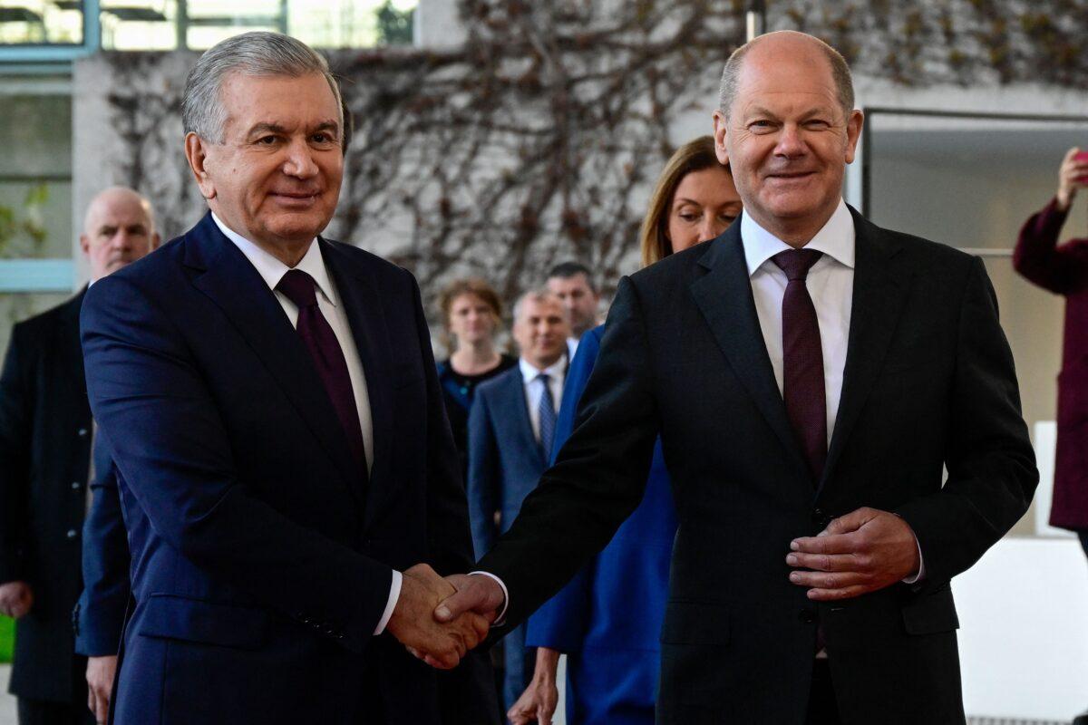 German Chancellor Olaf Scholz (R) and Uzbek President Shavkat Mirziyoyev shake hands as he arrives at the Chancellery in Berlin on May 2, 2023. (John Macdougall/AFP via Getty Images)