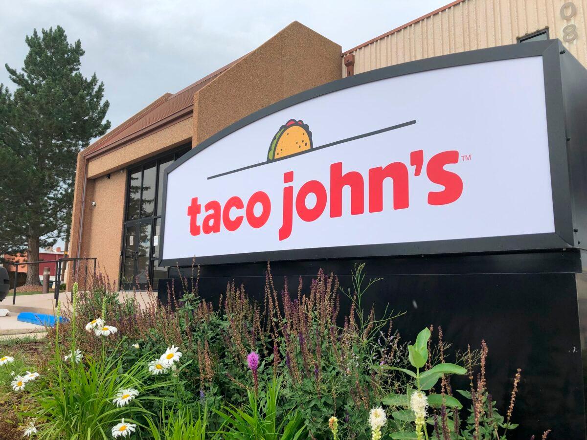 A sign stands outside the corporate headquarters of Cheyenne-based Taco John's in Cheyenne, Wyo., on Aug. 1, 2019. (Mead Gruver/AP Photo)