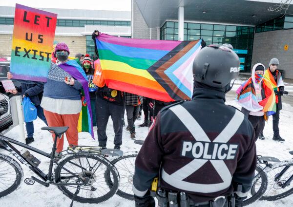 Protestors in favour of drag queen story hour gather for a "Reading with Royalty" event as police look on at a library branch in Calgary, Alberta, on Monday, March 27, 2023. This protest is not banned under the bylaw because it does not express "objection or disapproval". (Jeff McIntosh/The Canadian Press)