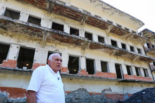 Former political prisoner, Saimir Maloku, poses in front of the dormitories on June 23, 2017 near the village of Reps, northwestern Albania, at the former Spac prison, a labour camp established in 1968 by the communist regime of Albania at the site of a mine. (Gent Shkulaku/AFP via Getty Images)