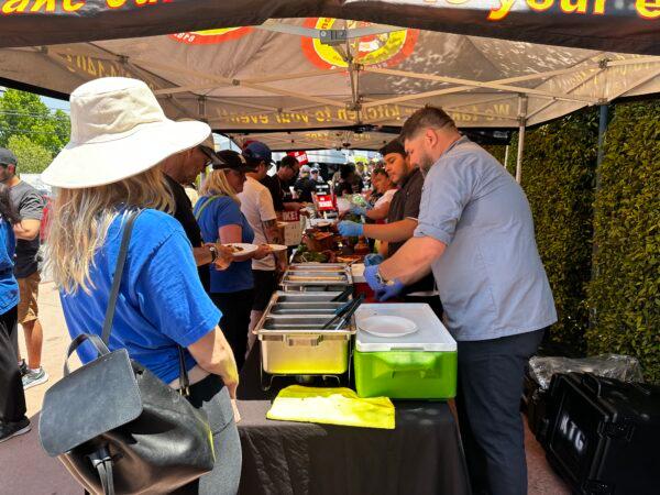 Nonna’s Kitchen, a catering business in Sherman Oaks, Calif., donates and serves food to members of the Writers Guild of America picketing in front of the Walt Disney Co.'s corporate headquarters in Burbank, Calif., on May 17, 2023. (Jill McLaughlin/The Epoch Times)