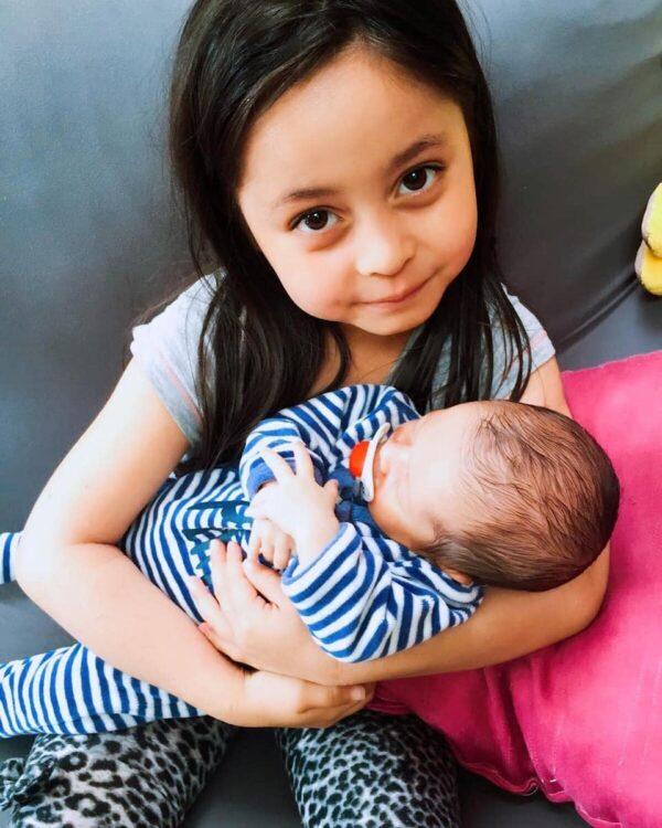 Big sister Alyssa holding her baby brother. (Courtesy of Hebe)