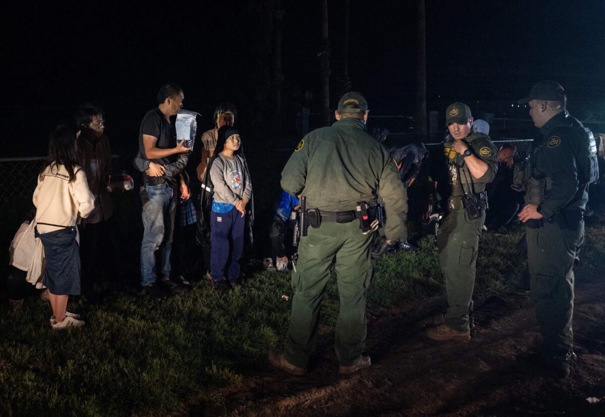 US Border Patrol agents keep watch over illegal immigrants in Fronton, Texas, on May 12, 2023. (Andrew Caballero-Reynolds/AFP via Getty Images)