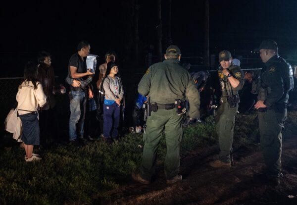 U.S. Border Patrol agents keep watch over illegal immigrants in Fronton, Texas, on May 12, 2023. (Andrew Caballero-Reynolds/AFP via Getty Images)